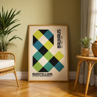 Retro art poster leaning near chair and potted plant in soft lighting
