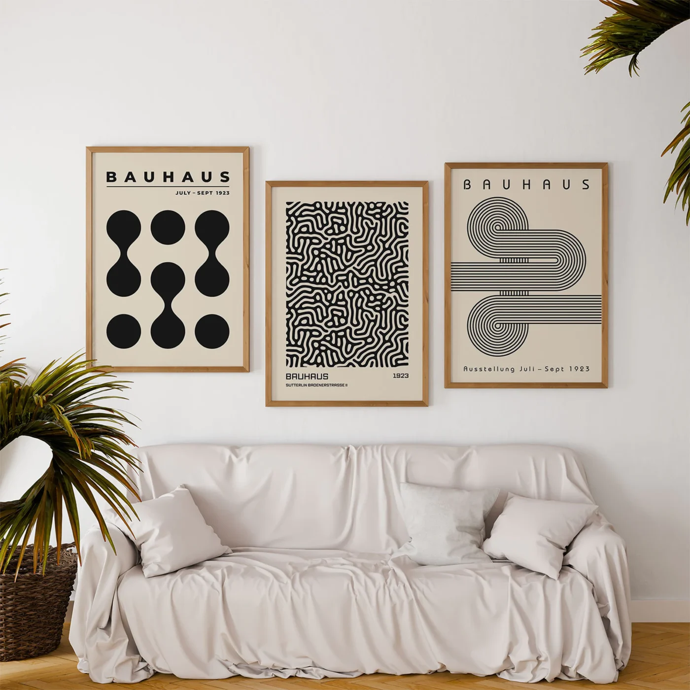 Minimalist Bauhaus prints above neutral sofa in cozy living room interior