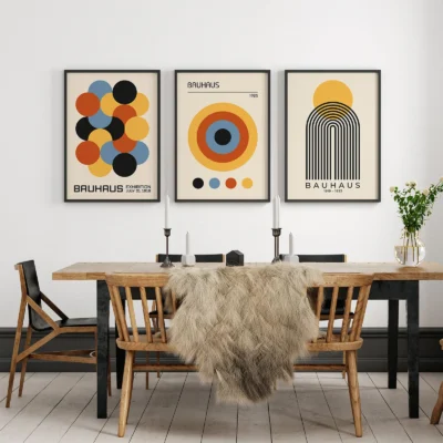 Bauhaus set poster trio displayed in dining room with wood furniture