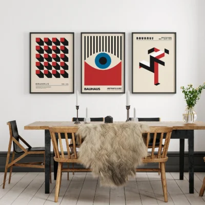 Geometric Bauhaus art prints in black, red, and blue above dining table