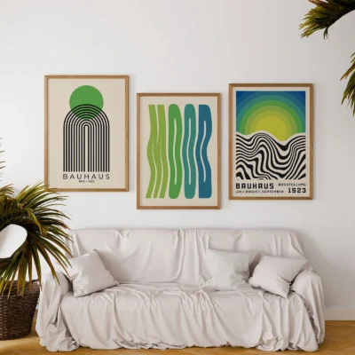 Mid century posters in green and blue above white sofa with plants