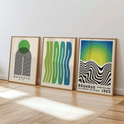 Bauhaus posters in green and blue leaning against wall in bright interior
