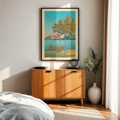 Kawase Hasui poster hung on white wall above wooden sideboard in natural light