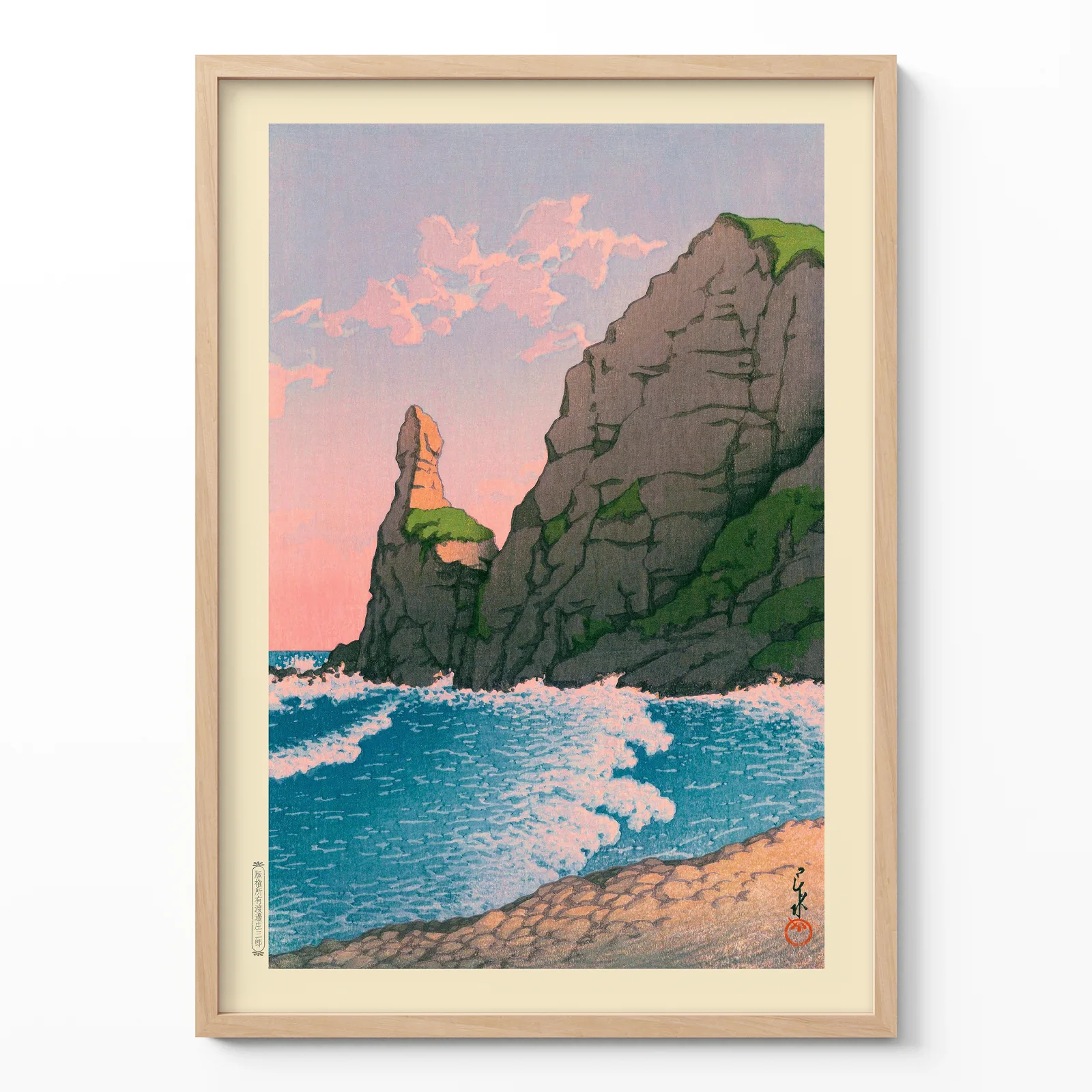 Kawase Hasui woodblock print showing Setakamu Rocks and waves in wooden frame on cream background