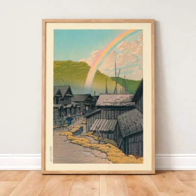 Kawase Hasui artwork leaning on wooden floor, rainbow above rural rooftops and green hills