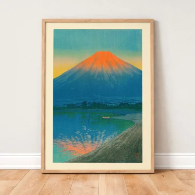 Japanese print leaning on wall, vibrant Mount Fuji and lake scene in soft morning light