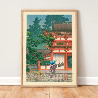 Japanese wall art leaning on floor, red shrine and woman with umbrella in rainy weather