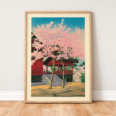 Japanese vintage poster leaning on wall, temple with pink sakura trees and bright sky