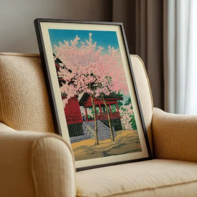 Japanese vintage poster on beige chair, framed print of sakura trees and shrine