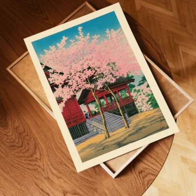 Unframed Japanese vintage poster of temple and sakura laid on wooden tray