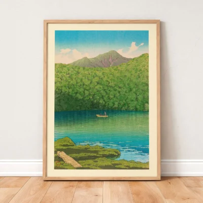 Framed vintage Japanese poster leaning on wall, morning lake scene